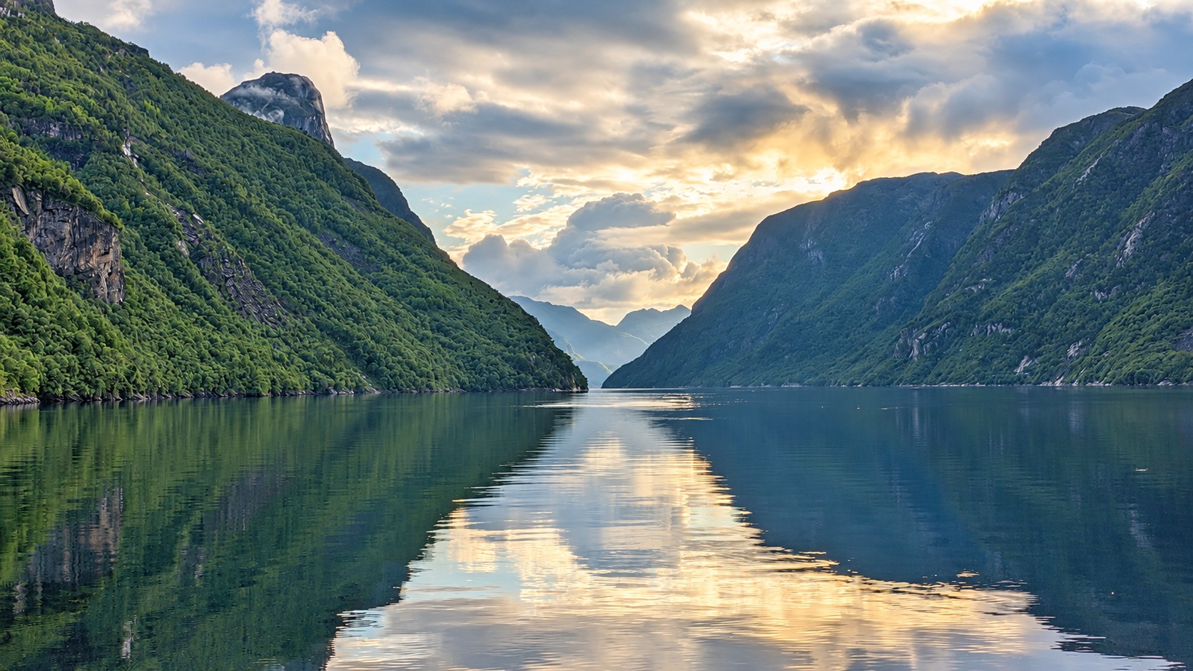 View along the Frafjord with wooded mountains and calm water